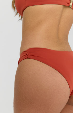 NIXIE ASYMMETRIC RING BIKINI BRIEF - RUST ORANGE